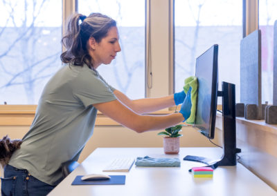 woman cleaning computer screen